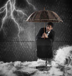 Frightened man protects himself with an umbrella