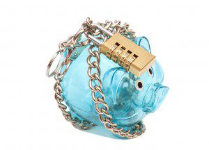 Piggy bank padlocked with chains and padlock on white background