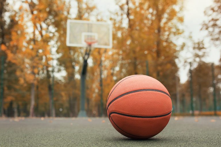 Basketball laying on ground near hoop
